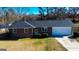Charming brick home featuring an attached garage and well-maintained front yard at 6268 Mount Zion Blvd, Morrow, GA 30260