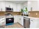 A modern kitchen with stainless steel appliances, white cabinets, and light countertops at 6268 Mount Zion Blvd, Morrow, GA 30260
