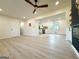 An open living room with modern floors leading to a kitchen area with white cabinets at 6268 Mount Zion Blvd, Morrow, GA 30260