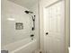 Stylish shower boasts white tile, black fixtures, and a built-in niche for toiletries at 6268 Mount Zion Blvd, Morrow, GA 30260