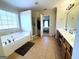 Elegant bathroom with a soaking tub, walk-in shower, and double sink vanity at 1441 Henderson Ridge Ln, Loganville, GA 30052
