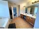 Spacious primary bathroom featuring double vanity, separate tub, and tile flooring at 1441 Henderson Ridge Ln, Loganville, GA 30052