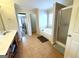A luxurious bathroom boasting a soaking tub, shower, and stylish tile flooring at 1441 Henderson Ridge Ln, Loganville, GA 30052
