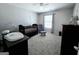 Serene Bedroom with a crib, glider, and soft gray carpet and paint at 1441 Henderson Ridge Ln, Loganville, GA 30052