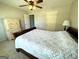 Well-lit bedroom featuring a ceiling fan, comfortable bed, and a classic white dresser at 1441 Henderson Ridge Ln, Loganville, GA 30052