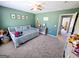 Comfortable bedroom featuring a ceiling fan, soothing green walls, and playful decor at 1441 Henderson Ridge Ln, Loganville, GA 30052