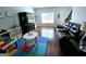 Cozy bonus room with hardwood floors, a leather sofa, and lots of natural light at 1441 Henderson Ridge Ln, Loganville, GA 30052
