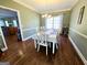 Traditional dining room featuring hardwood floors and a large table with seating for six at 1441 Henderson Ridge Ln, Loganville, GA 30052
