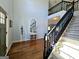 Bright foyer with hardwood floors, a staircase with black railing and a decorative display at 1441 Henderson Ridge Ln, Loganville, GA 30052