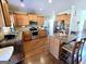 Open kitchen with stainless steel appliances, granite countertops, wood cabinets, and hardwood floors at 1441 Henderson Ridge Ln, Loganville, GA 30052