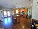 Open kitchen with wood cabinets, a granite island, stainless steel appliances, and hardwood floors at 1441 Henderson Ridge Ln, Loganville, GA 30052