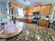 Kitchen featuring granite countertops, stainless steel appliances and wood cabinets at 1441 Henderson Ridge Ln, Loganville, GA 30052