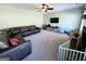 Spacious living room with a ceiling fan, a large leather sectional, and neutral carpet at 1441 Henderson Ridge Ln, Loganville, GA 30052