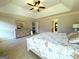Large Primary bedroom features a tray ceiling, dresser, and hallway leading to other rooms at 1441 Henderson Ridge Ln, Loganville, GA 30052