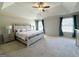 Spacious Primary bedroom features a tray ceiling, plush carpet, and ample natural light at 1441 Henderson Ridge Ln, Loganville, GA 30052