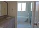 Modern bathroom with a soaking tub, frameless shower, and granite countertop vanity at 721 Cascade Sw Ave, Atlanta, GA 30310