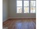 Bright bedroom with hardwood flooring and large windows, offering views of the neighborhood at 721 Cascade Sw Ave, Atlanta, GA 30310