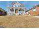 Charming two-story home with a welcoming front porch and bright yellow door at 721 Cascade Sw Ave, Atlanta, GA 30310