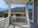 View from a covered front porch with white railings and a glimpse of a neighbor's brick home at 721 Cascade Sw Ave, Atlanta, GA 30310