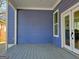 Covered porch boasts durable flooring, stylish blue siding, and a view of the home's exterior at 721 Cascade Sw Ave, Atlanta, GA 30310
