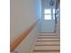 Bright staircase with wood handrail and decorative light fixture, leading to the upper level at 721 Cascade Sw Ave, Atlanta, GA 30310