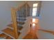 A well-lit staircase with wood steps and wrought iron railing, leading to the main floor at 721 Cascade Sw Ave, Atlanta, GA 30310
