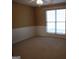 Spacious bedroom with carpet floors, neutral walls and a ceiling fan. Large window provides natural light at 180 Sunderland Cir, Fayetteville, GA 30215
