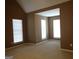 Bedroom featuring high ceilings, carpet floors, and multiple windows with blinds for natural light at 180 Sunderland Cir, Fayetteville, GA 30215