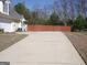 Long driveway leading to a two-car garage, with a view of the side yard and fence at 180 Sunderland Cir, Fayetteville, GA 30215