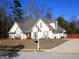Well-maintained home features a lush lawn, attached garage, and complementary gray shutters at 180 Sunderland Cir, Fayetteville, GA 30215