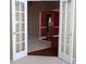 Home foyer featuring hardwood floors and views into the living and dining spaces through French doors at 180 Sunderland Cir, Fayetteville, GA 30215