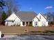 Charming single-story home features a symmetrical design, complemented by gray shutters and a lush front lawn at 180 Sunderland Cir, Fayetteville, GA 30215