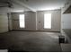 A clean garage features natural light, storage shelves, and a smooth concrete floor at 180 Sunderland Cir, Fayetteville, GA 30215