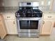 Stainless steel gas range oven with speckled granite countertops and white wooden cabinets at 180 Sunderland Cir, Fayetteville, GA 30215