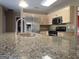 Modern kitchen features a large speckled granite countertop and stainless steel appliances at 180 Sunderland Cir, Fayetteville, GA 30215