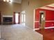 Open-concept living room with a fireplace, large windows, and a view into the dining area at 180 Sunderland Cir, Fayetteville, GA 30215