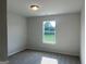 Neutral bedroom with carpeted floors and a large window with a view to the backyard at 4130 Chapel Hill Reserve, Douglasville, GA 30135