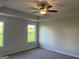 Spacious bedroom featuring neutral walls, large windows, and a modern ceiling fan at 4130 Chapel Hill Reserve, Douglasville, GA 30135