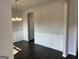 Classic dining room with dark wood floors, white wainscoting, and decorative chandelier at 4130 Chapel Hill Reserve, Douglasville, GA 30135