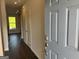 View of the home's entryway with wood floors leading to a naturally lit living area at 4130 Chapel Hill Reserve, Douglasville, GA 30135