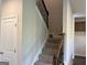 Carpeted stairway with wood railing and black wrought iron spindles at 4130 Chapel Hill Reserve, Douglasville, GA 30135