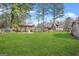 Expansive backyard features lush lawn, mature trees, and an outdoor swing set at 2759 Turner Valley Sw Cir, Conyers, GA 30094