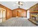 Spacious living room featuring a stone fireplace, wood paneling, and neutral carpeting at 2759 Turner Valley Sw Cir, Conyers, GA 30094