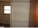 Bedroom with an empty built in bookshelf, and a window providing natural light at 2102 Mulkey Sw Rd, Marietta, GA 30008