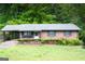 Charming brick ranch home with a well-maintained front yard and covered carport at 2102 Mulkey Sw Rd, Marietta, GA 30008