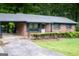 A brick ranch home featuring a covered carport and a neatly kept front yard at 2102 Mulkey Sw Rd, Marietta, GA 30008