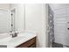 Bathroom featuring a wood vanity cabinet, white countertop, and framed mirror at 3863 Rosebay Way, Conyers, GA 30094
