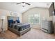 Bright bedroom featuring a bed, dresser, window and vaulted ceilings at 3863 Rosebay Way, Conyers, GA 30094