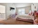 Bedroom featuring light pinks, a TV, and a sunny window at 3863 Rosebay Way, Conyers, GA 30094