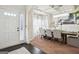 Elegant dining room with a modern chandelier, large windows, and a formal dining table set for a meal at 3863 Rosebay Way, Conyers, GA 30094